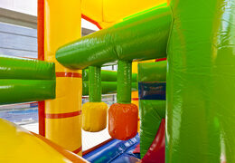 Multiplay lion bouncer with a slide, pillars on the jumping surface and striking 3D objects for children. Order inflatable bouncers online at JB Inflatables UK