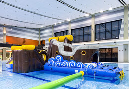 Order an inflatable airtight pirate play island with a vine, climbing tower, round slide and obstacles for both young and old. Buy inflatable water attractions online now at JB Inflatables America