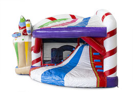 Bouncy castle in candyland theme with a slide for children. Buy inflatable bouncy castles online at JB Inflatables UK