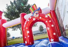 Bounce World circus bouncer with slides and all kinds of obstacles with circus prints for kids. Order bouncers online at JB Inflatables UK