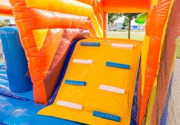 Inflatable covered bouncer in a pirate theme with a slide on the jumping surface, climbing tower and fun obstacles for kids. Buy bouncers online at JB Inflatables UK