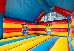 Big super bounce house covered with cheerful animations in pirate theme for children. Order bounce houses online at JB Inflatables UK