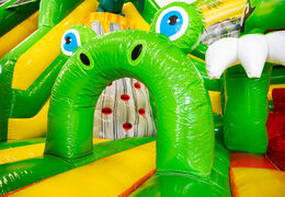 Inside of Slideworld dino green yellow bounce house
