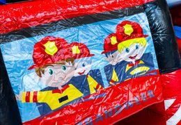 Inflatable castle fire theme with illustration of firefighters in a van, order online