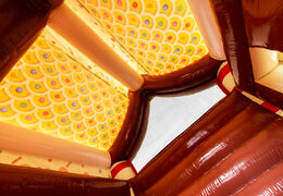 Roof of covered bouncy castle decorated as gingerbread house in gingerbread theme