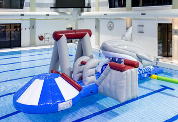 Order an inflatable airtight shark play island with a vine, climbing tower, round slide and obstacles for both young and old. Buy inflatable water attractions online now at JB Inflatables America