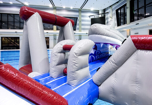 Order an airtight inflatable play island in a shark theme with a liana, climbing tower, round slide and obstacles for both young and old. Buy inflatable pool games now online at JB Inflatables America