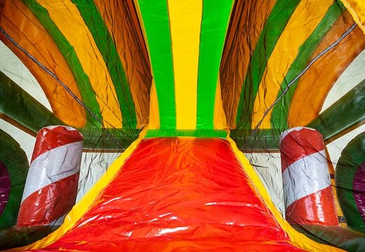 Multiplay XXL Jungleworld bouncy castle in a unique design with two entrances, a slide in the middle and 3D objects for children to order. Buy bouncy castles online at JB Inflatables UK