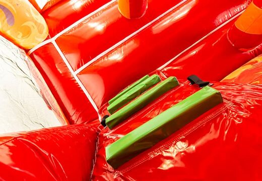 Indoor multiplay fire brigade bouncer in a unique design with two entrances, a slide in the middle and 3D objects for kids to order. Buy bouncers online at JB Inflatables UK