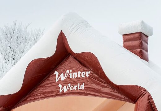 Skihut winterworld bounce house with a 3D chimney at the top for children. Bounce houses for sale online at JB Inflatables UK